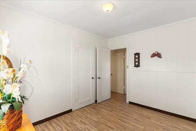 a view of a room with wooden floor