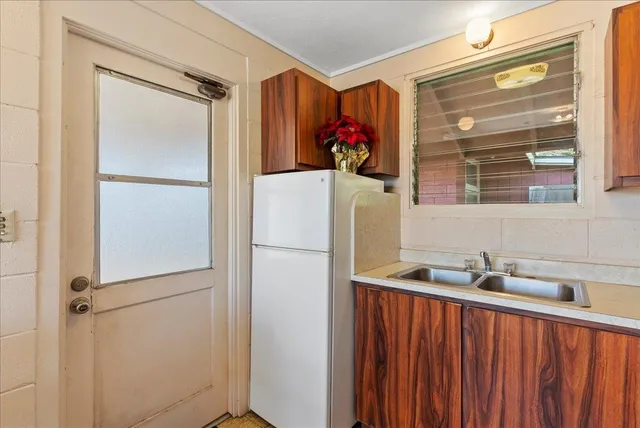 a kitchen with a refrigerator and a cabinets