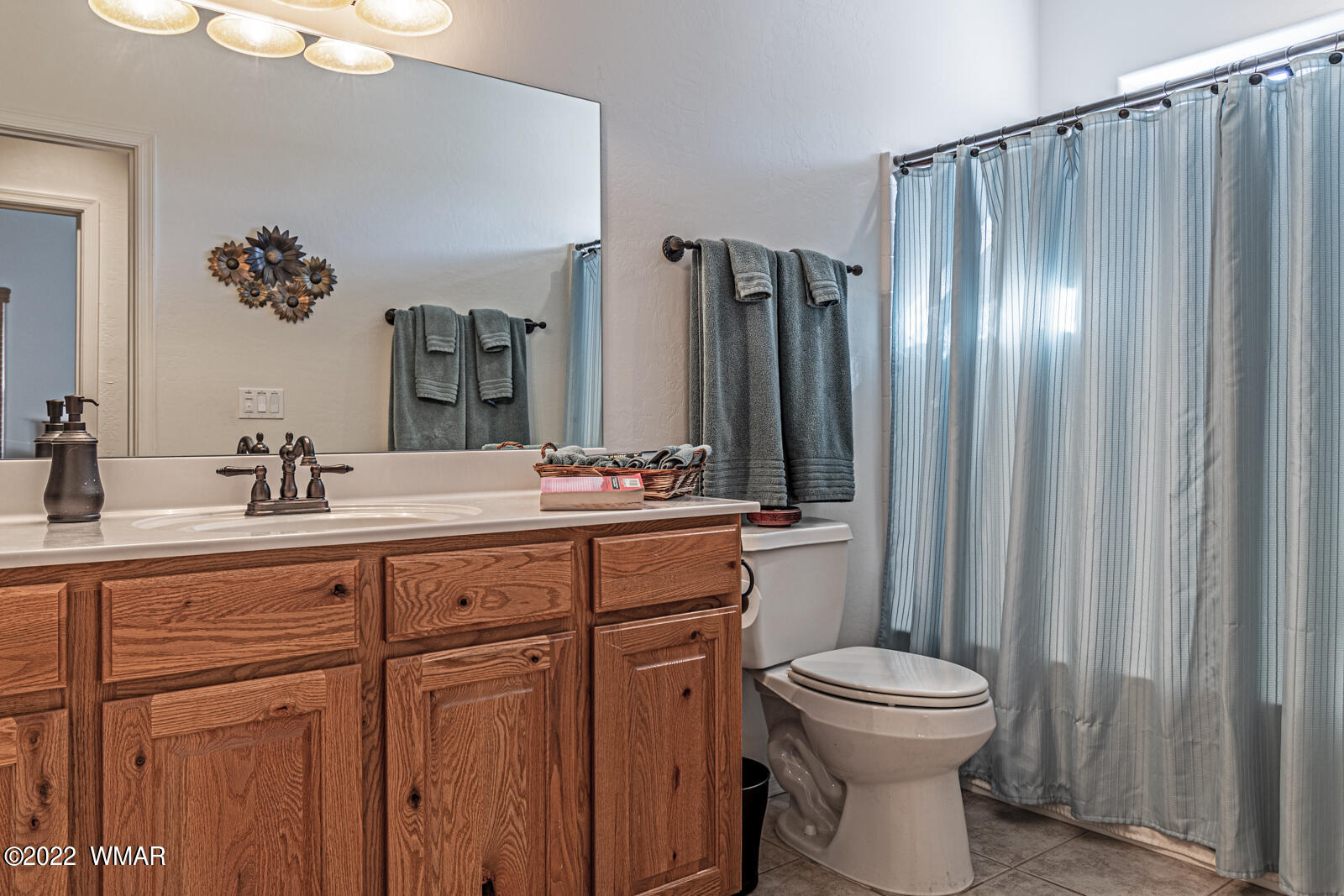 931 Cedar Ridge Run Show Low, AZ 85901 - Photo 16 of 20 a bathroom with a toilet sink and mirror