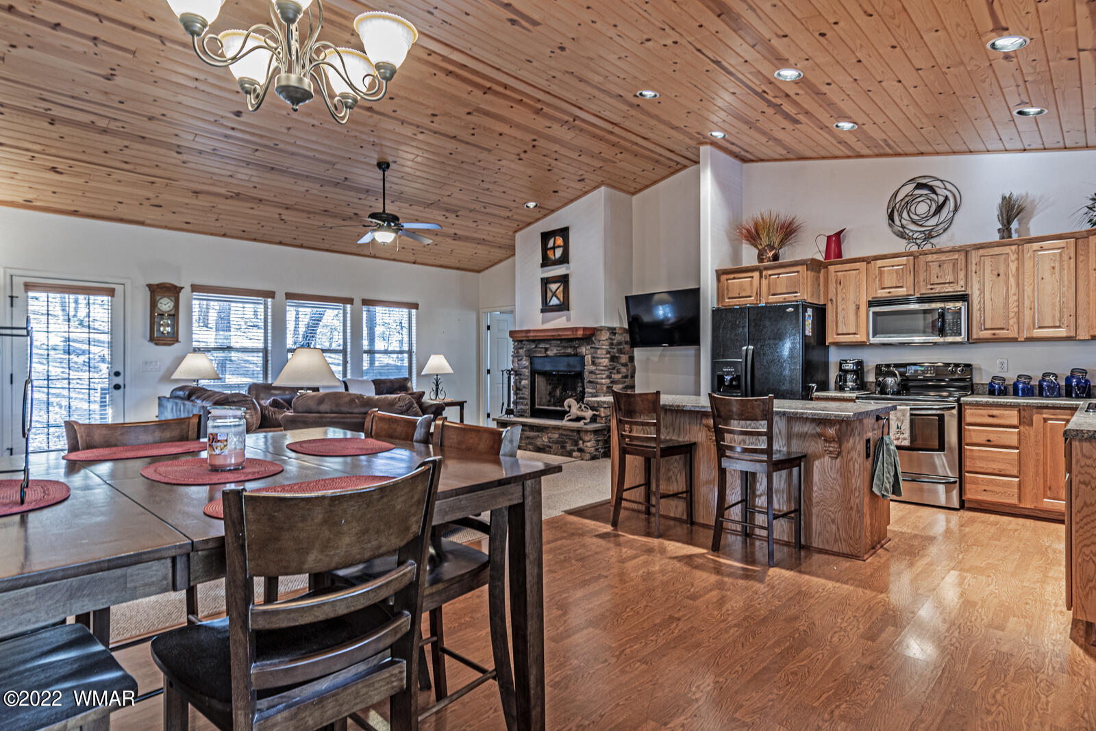 931 Cedar Ridge Run Show Low, AZ 85901 - Photo 5 of 20 a open kitchen with stainless steel appliances kitchen island granite countertop a table chairs and a refrigerator