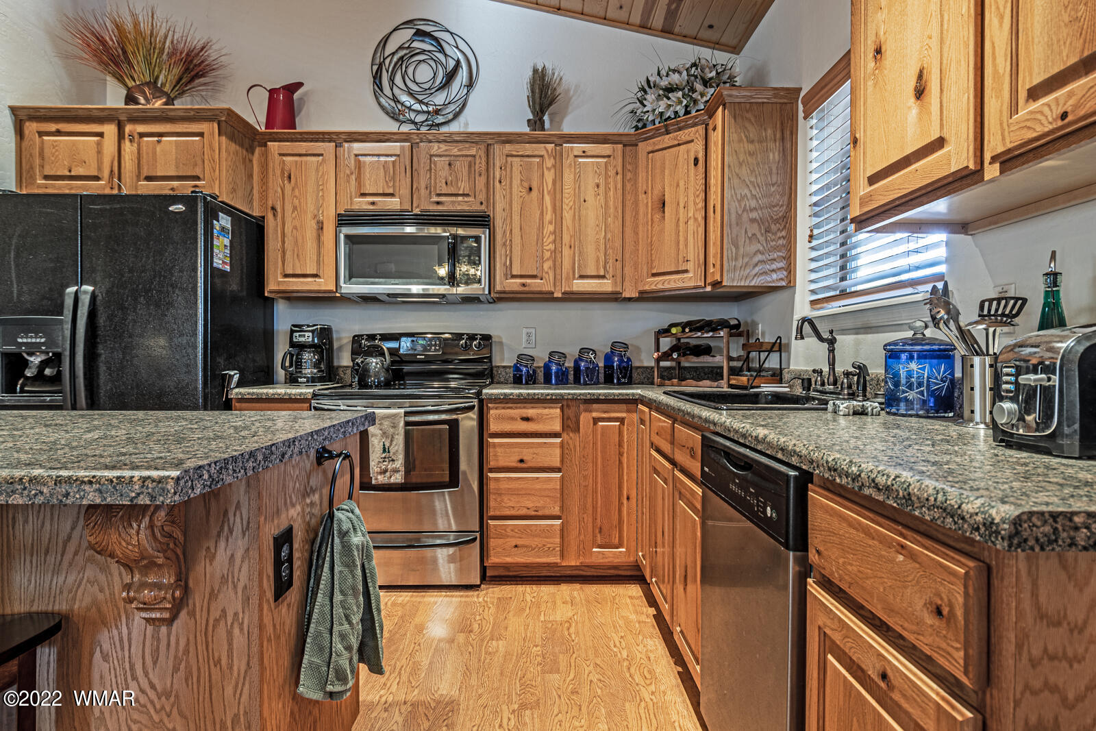 931 Cedar Ridge Run Show Low, AZ 85901 - Photo 8 of 20 a kitchen with stainless steel appliances granite countertop a stove a sink and a microwave