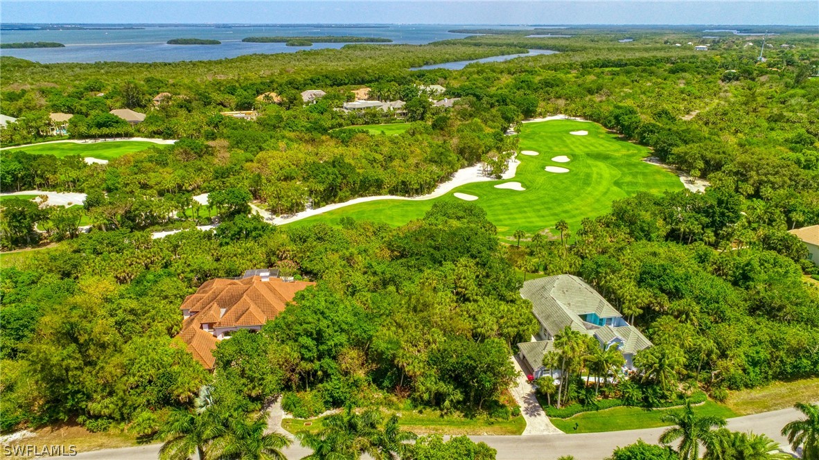 2462 Wulfert Road Sanibel, FL 33957 - Photo 9 of 14 a view of a green yard with large trees
