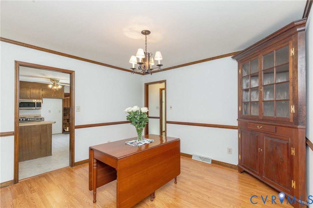 617 Rebel Ridge Road Colonial Heights, VA 23834 - Photo 15 of 49 a living room with furniture and a chandelier