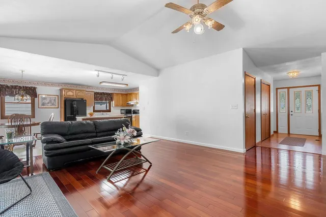 a living room with furniture windows and wooden floor