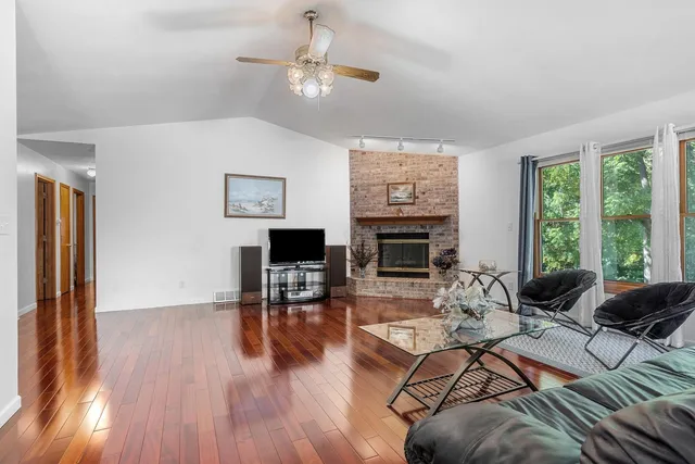 a living room with furniture fireplace and window