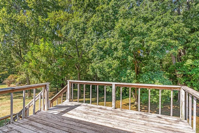 a view of a wooden deck and a yard