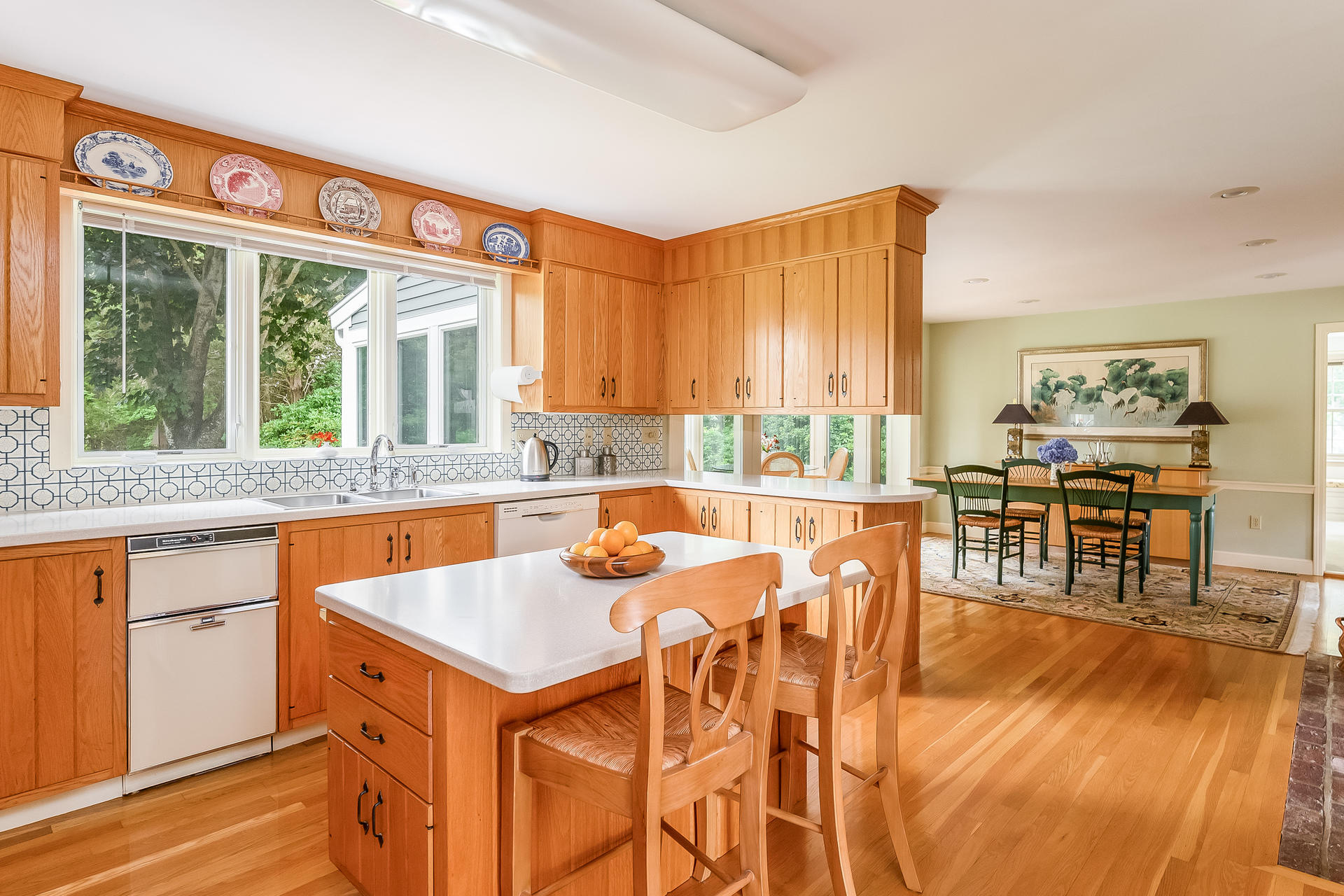 160 Point Hill Road West Barnstable, MA 02668 - Photo 13 of 39 a open kitchen with stainless steel appliances granite countertop a stove top oven a dining table and chairs with wooden floor