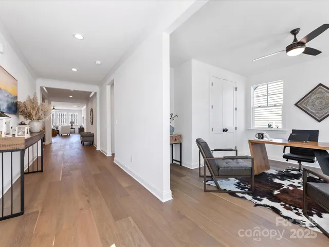 a view of a workspace with wooden floor and a window