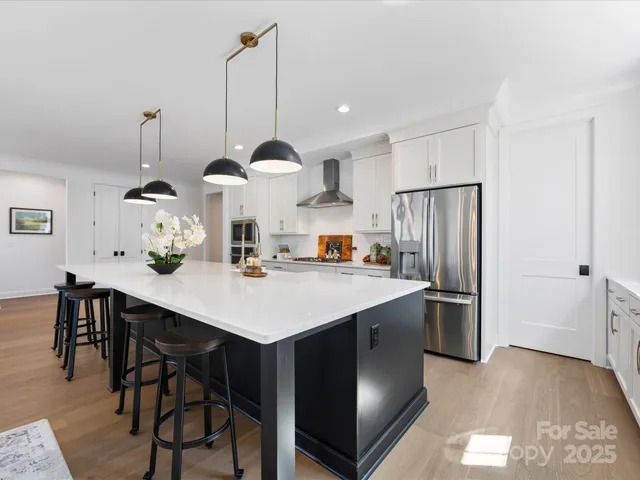 a kitchen with stainless steel appliances white cabinets and a window