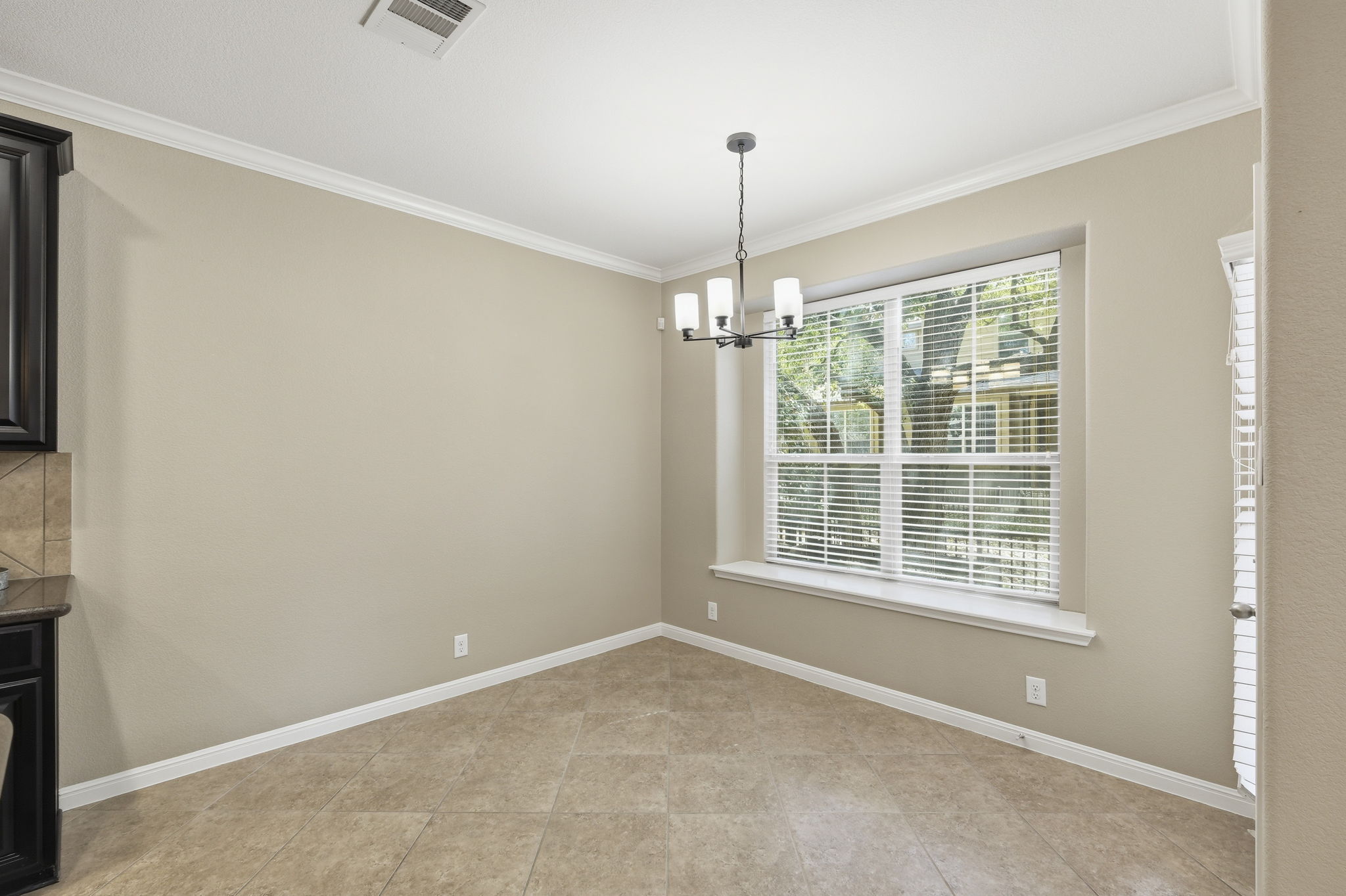 14001 Avery Ranch Boulevard, Unit 602 Austin, TX 78717 - Photo 10 of 39 Unfurnished dining area featuring ornamental molding and a chandelier