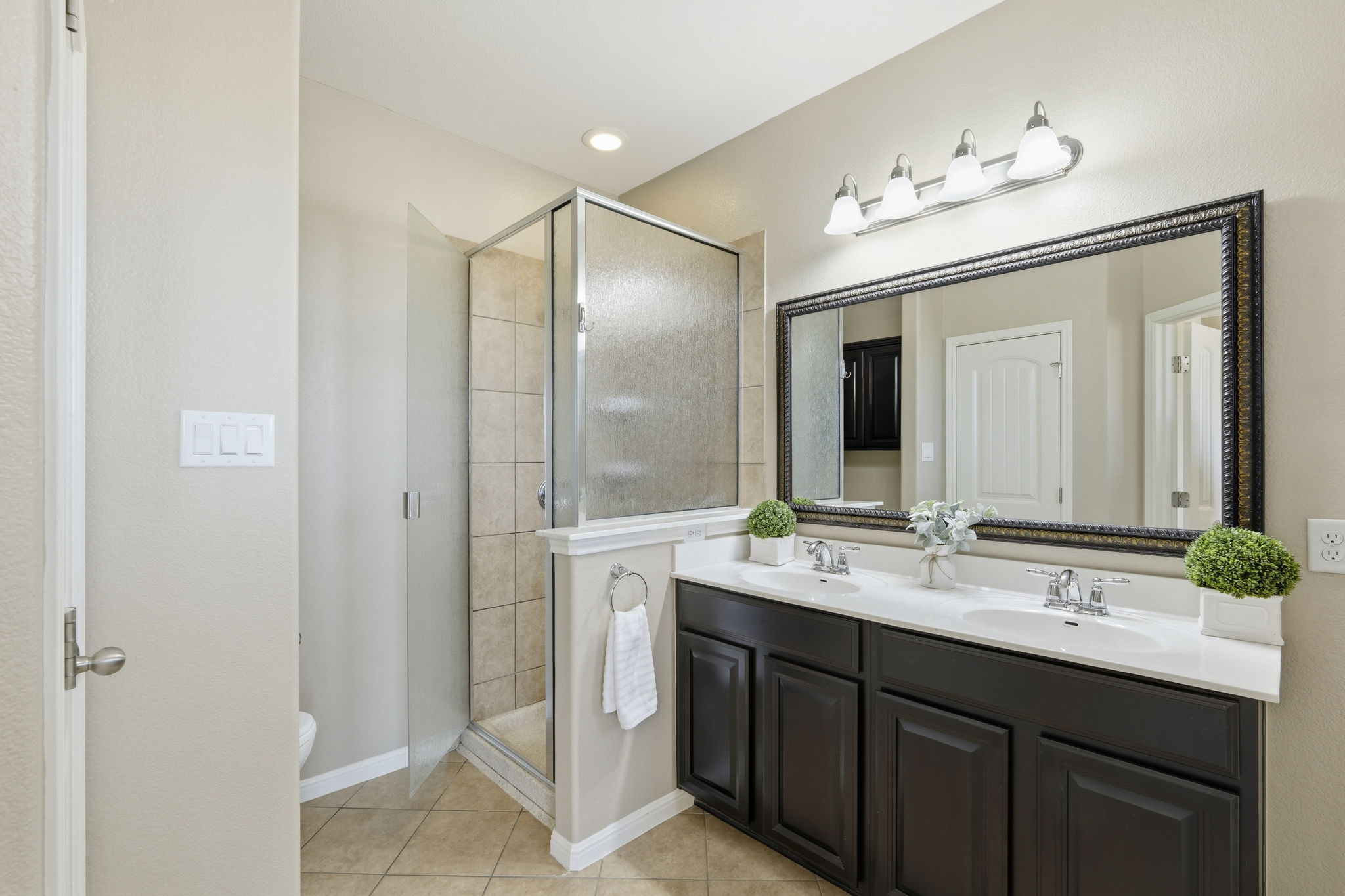 14001 Avery Ranch Boulevard, Unit 602 Austin, TX 78717 - Photo 16 of 39 Primary Bathroom Full bathroom featuring double vanity, a shower stall, and light tile patterned floors