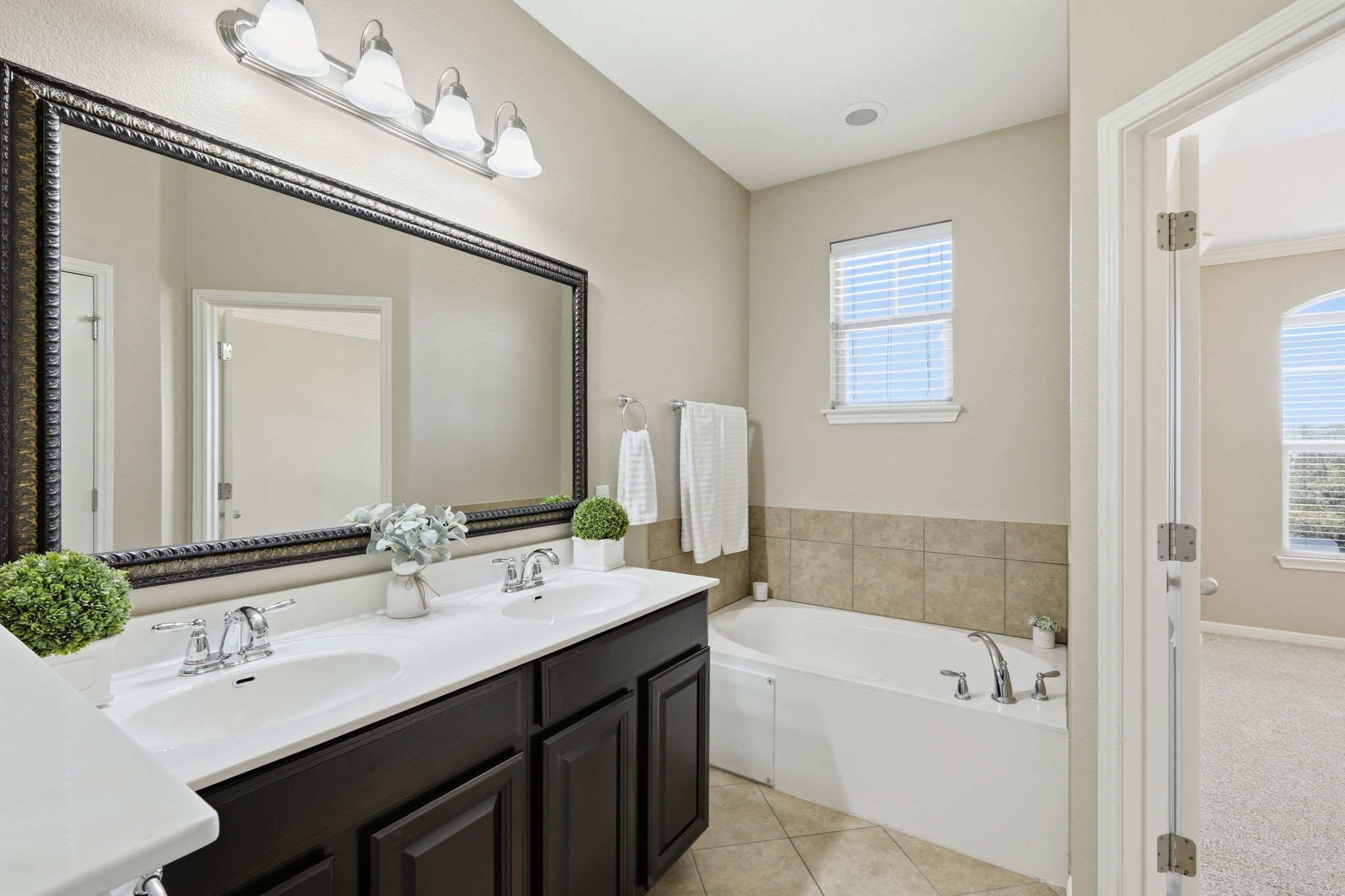 14001 Avery Ranch Boulevard, Unit 602 Austin, TX 78717 - Photo 17 of 39 Primary Bathroom with double vanity, a garden tub, and light tile patterned floors