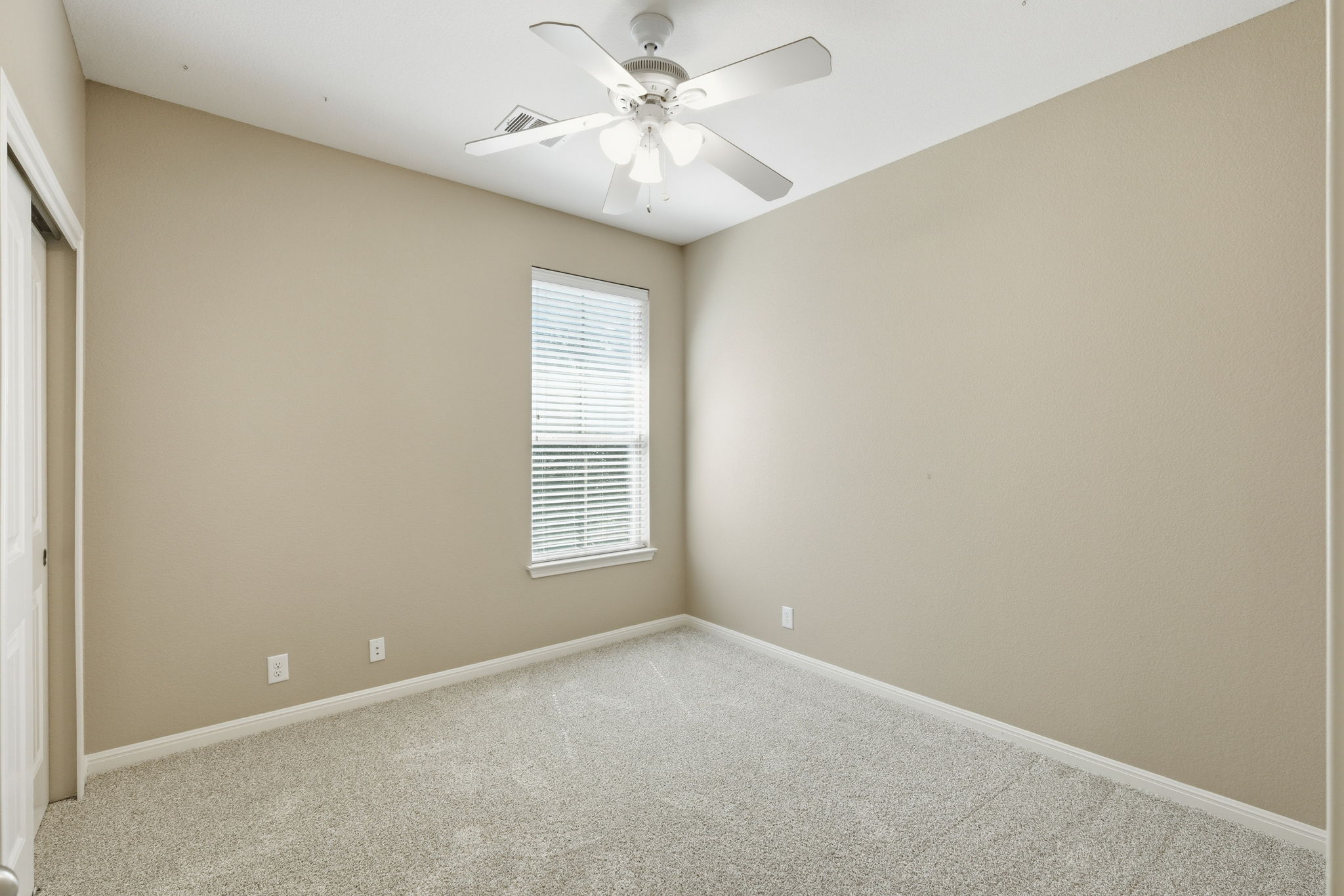 14001 Avery Ranch Boulevard, Unit 602 Austin, TX 78717 - Photo 21 of 39 Spare bedroom featuring light carpet, a closet, and ceiling fan