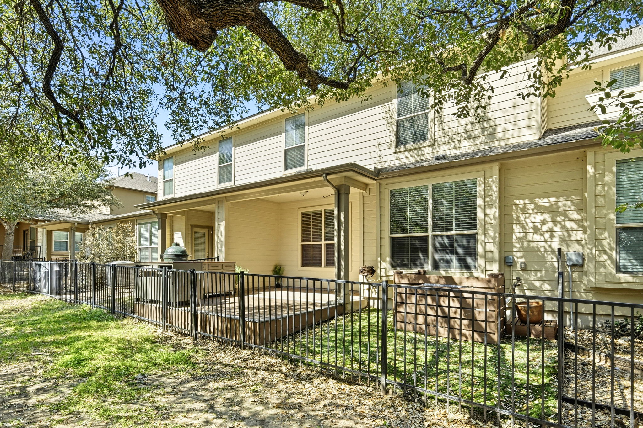 14001 Avery Ranch Boulevard, Unit 602 Austin, TX 78717 - Photo 26 of 39 Rear view of house with a fenced front yard, a patio area, and a gate