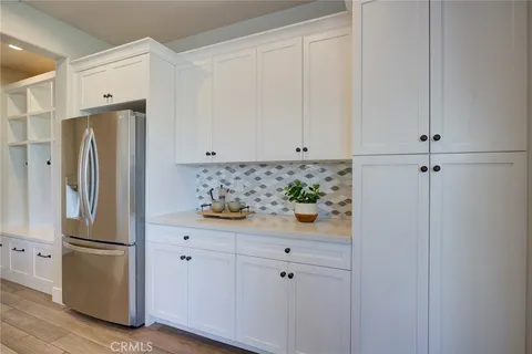 a kitchen with stainless steel appliances white cabinets and a refrigerator
