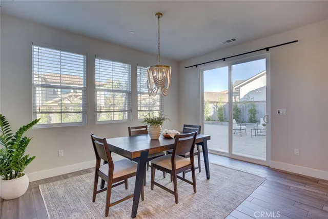 a dining room with furniture window and wooden floor