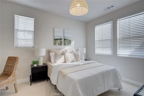 a bed room with a bed and a chair