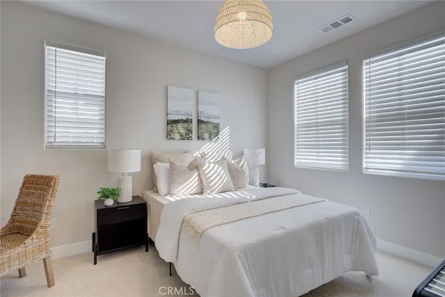 a bed room with a bed and a chair