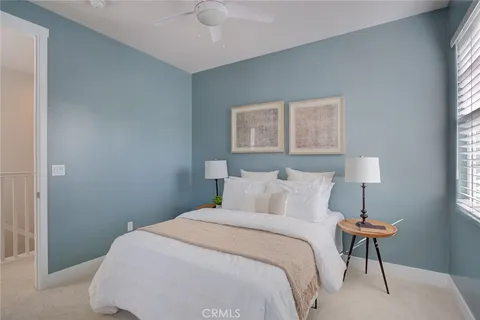 a bedroom with a bed and a lamp