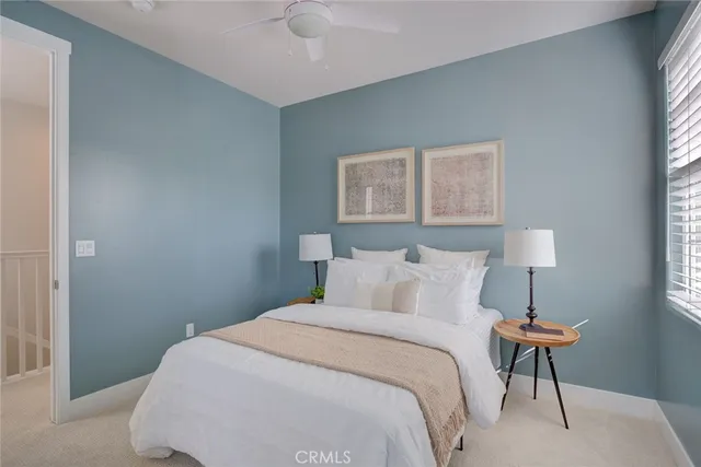 a bedroom with a bed and a lamp