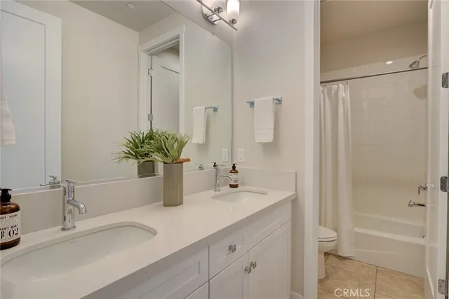 a bathroom with a sink a vanity a mirror and a bathtub