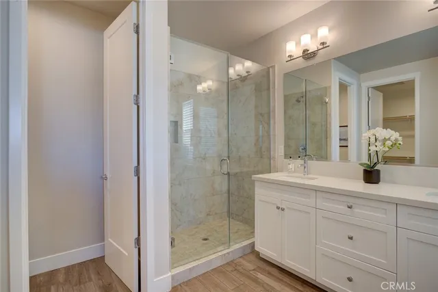 a bathroom with a shower sink and mirror