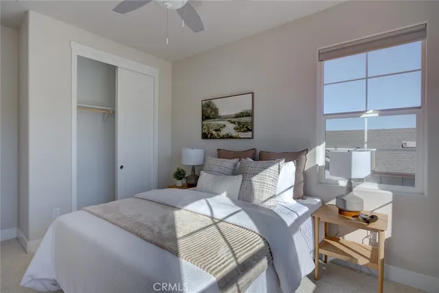 a bedroom with a bed and a painting on the wall