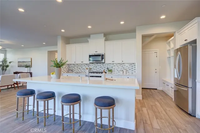 a kitchen with cabinets and stainless steel appliances