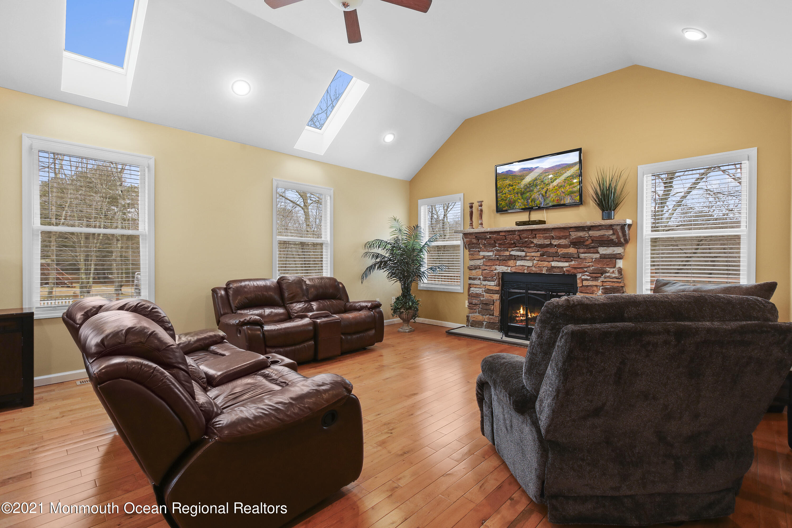 582 Reed Road Jackson, NJ 08527 - Photo 22 of 45 a living room with furniture a flat screen tv and a fireplace