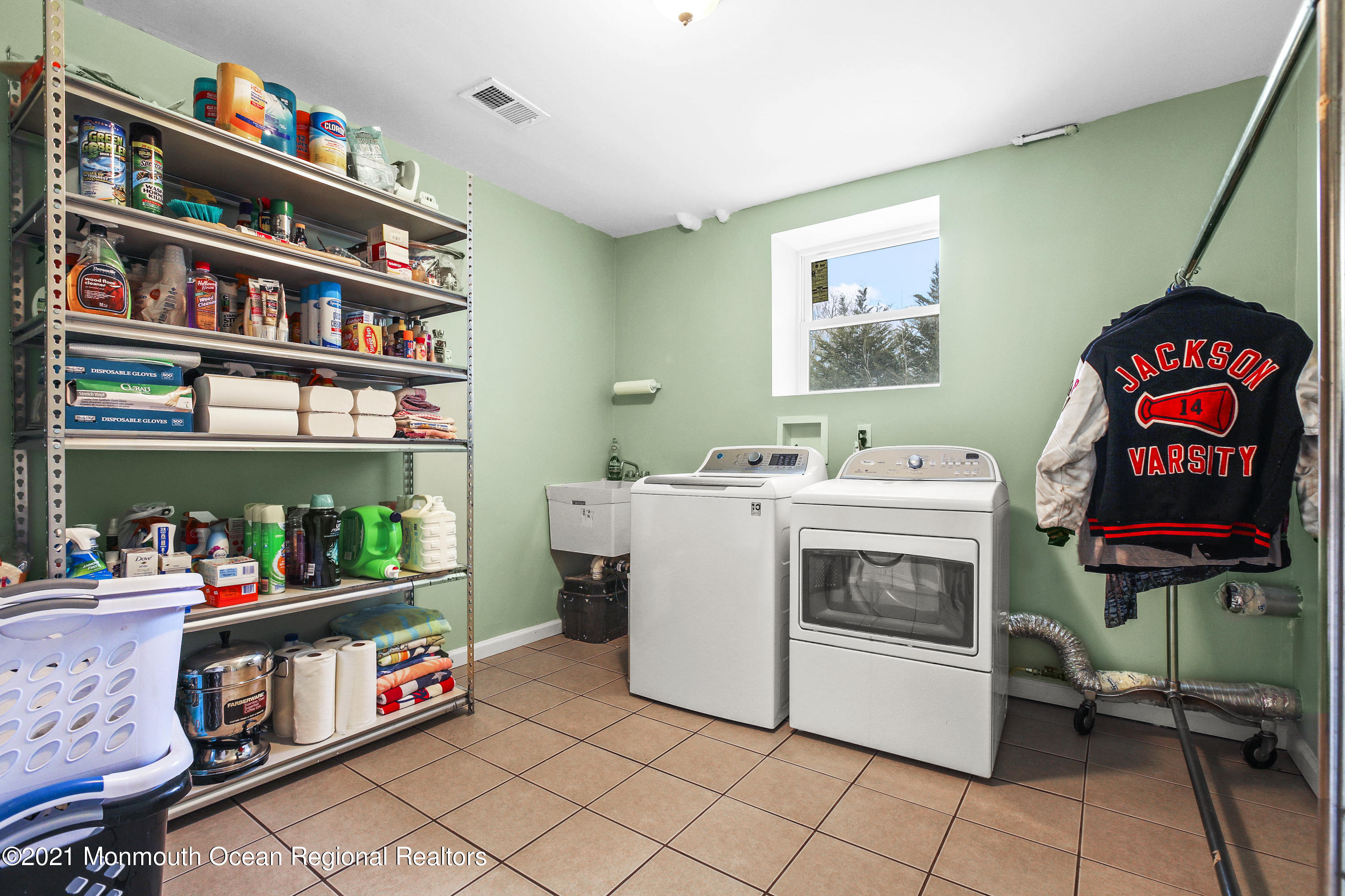 582 Reed Road Jackson, NJ 08527 - Photo 40 of 45 a utility room with fridge dryer and washer