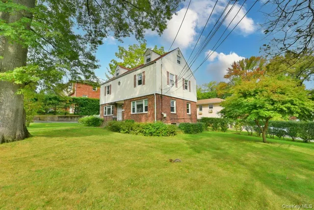 a view of a house with garden and trees