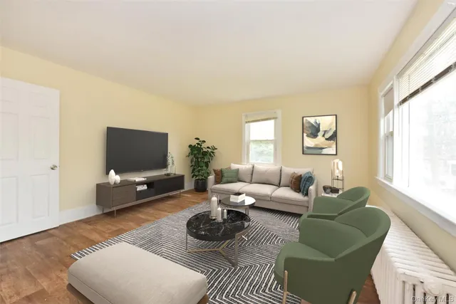 a living room with furniture a flat screen tv and a large window