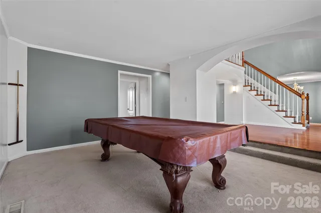 a spacious bedroom with a bed and a chandelier