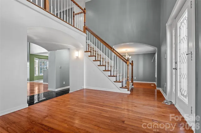 a view of entryway and hall with wooden floor