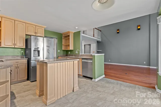 a kitchen with stainless steel appliances a refrigerator and cabinets