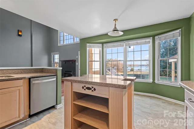 a very nice looking kitchen with granite countertop a stove and a sink