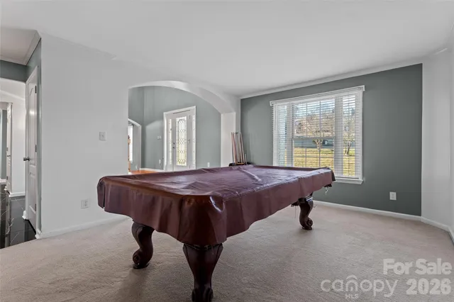 a spacious bedroom with a bed and a table