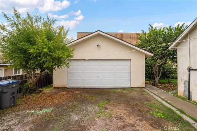 a view of a house with a yard and garage