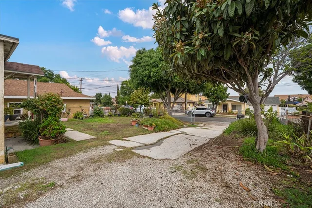 an aerial view of a house with a garden and a yard