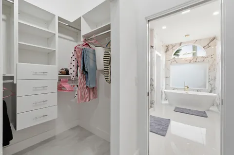 a bathroom with a bathtub sink and mirror