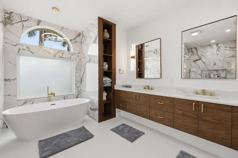 a bath tub sitting next to a bathroom sink