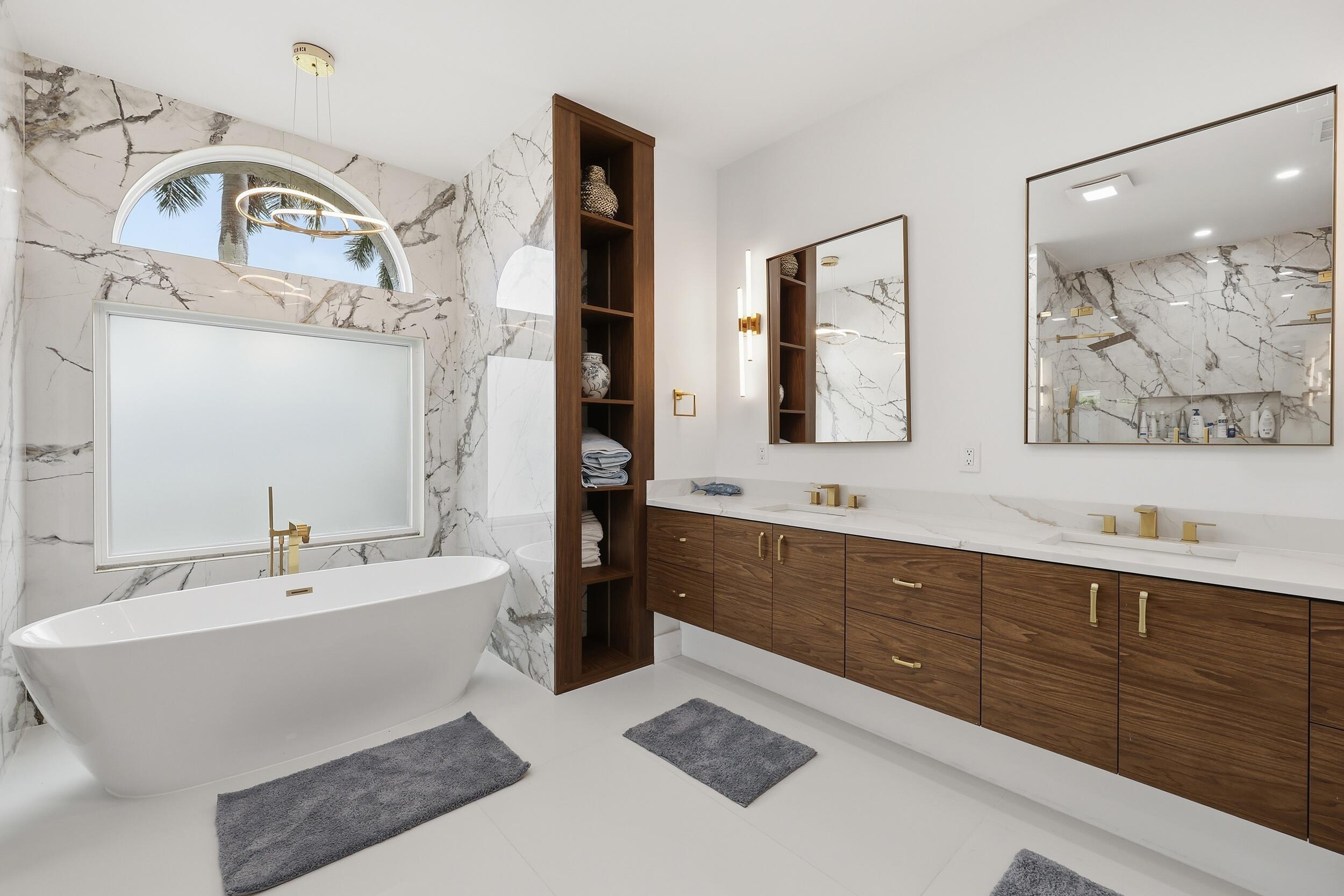 12363 Clearfalls Drive Boca Raton, FL 33428 - Photo 25 of 58 a spacious bathroom with a double vanity sink mirror and bathtub