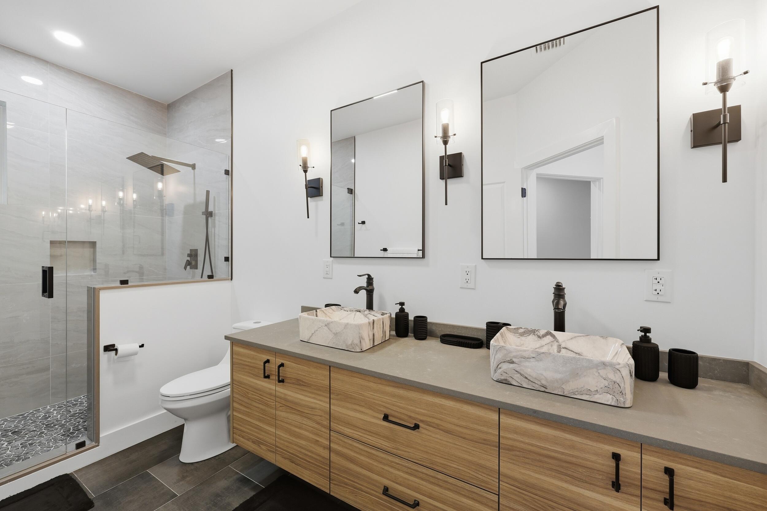 12363 Clearfalls Drive Boca Raton, FL 33428 - Photo 35 of 58 a bathroom with a granite countertop sink a toilet and a mirror