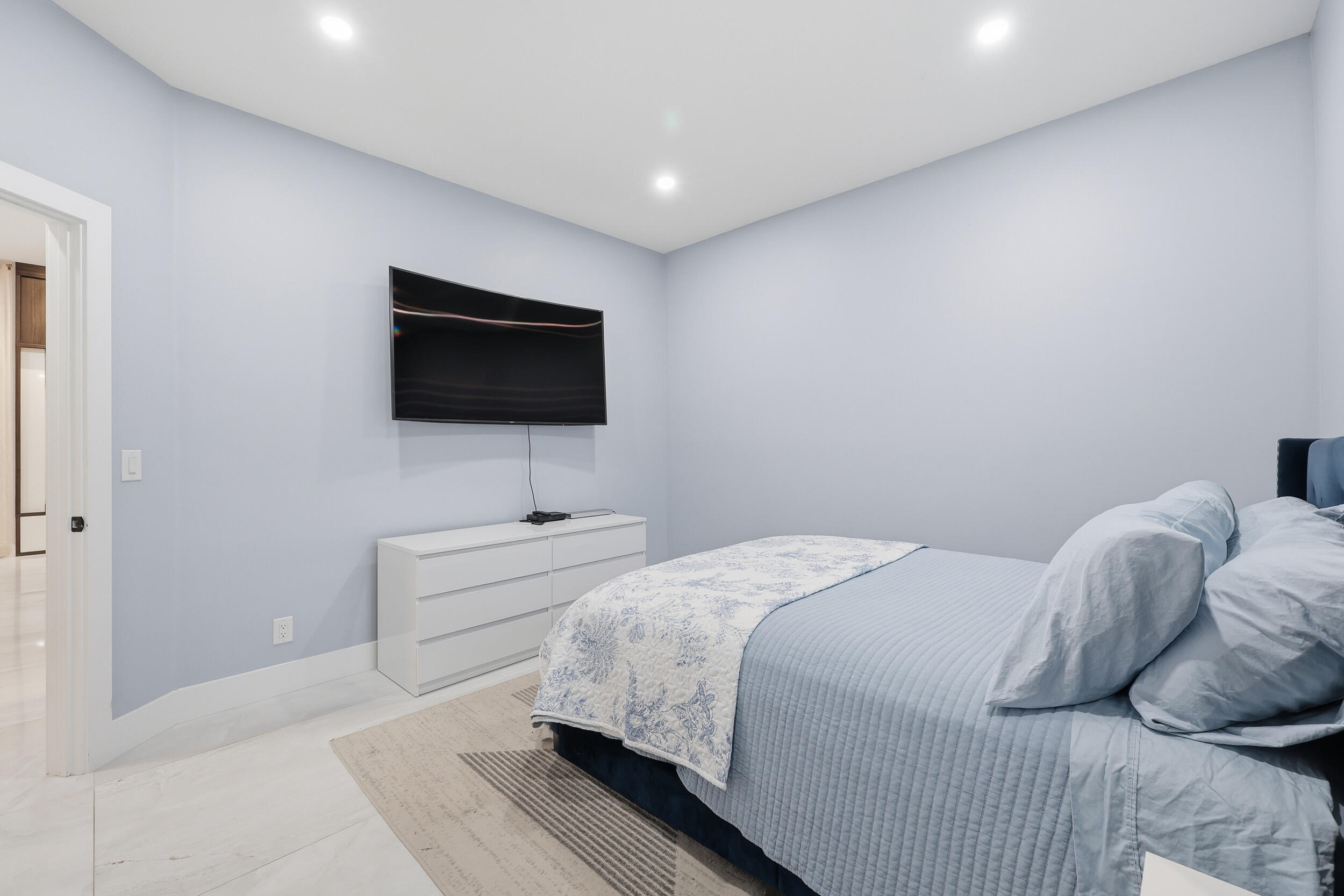 12363 Clearfalls Drive Boca Raton, FL 33428 - Photo 38 of 58 a bedroom with a bed and a flat screen tv