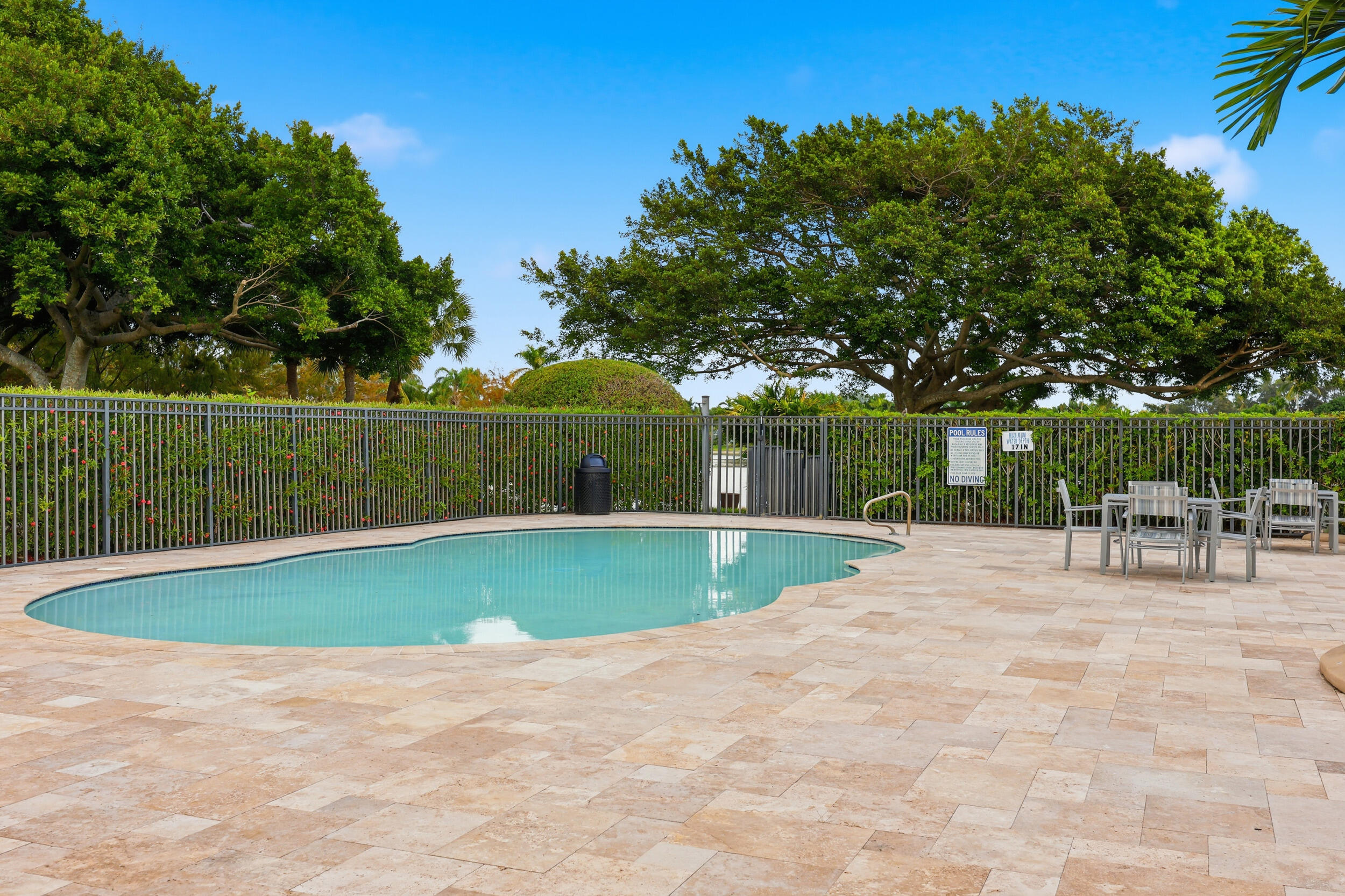 12363 Clearfalls Drive Boca Raton, FL 33428 - Photo 47 of 58 a view of a swimming pool with a patio and a garden