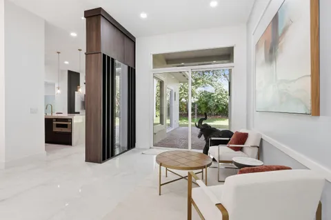 a large white kitchen with a large window