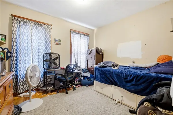 a living room with furniture a couch and dresser