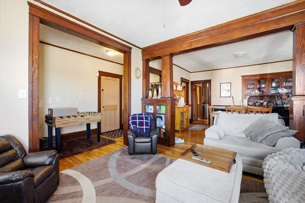 a living room with furniture and a floor to ceiling window