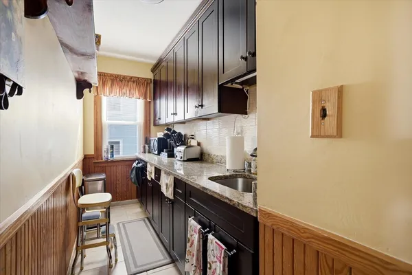 a kitchen with stainless steel appliances a sink stove and cabinets