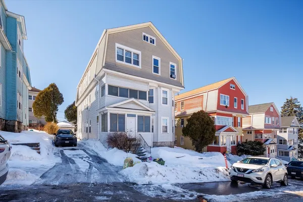 a front view of a residential apartment building with a yard